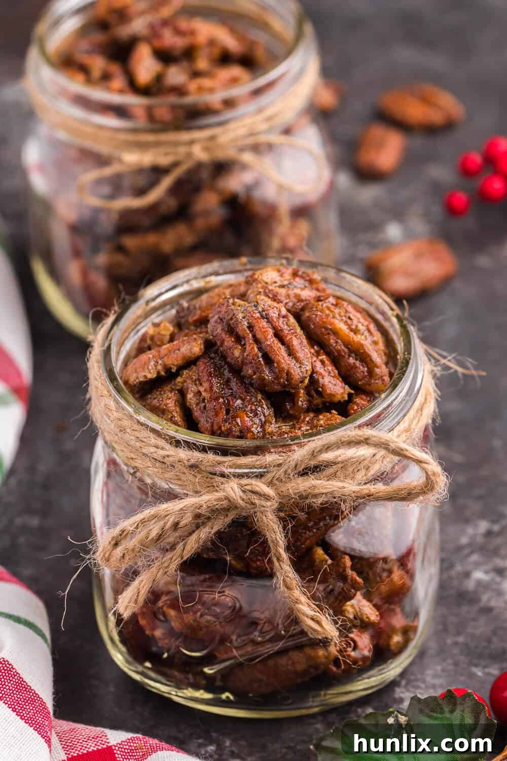 A classic ball mason jar filled with air fryer candied pecans, highlighting their golden-brown color and irresistible texture.