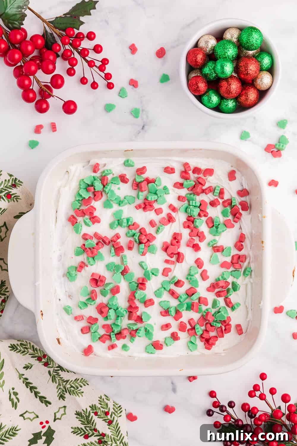 Festive Christmas Chewy Bars in a white baking pan, showcasing their bright colors and delicious texture.