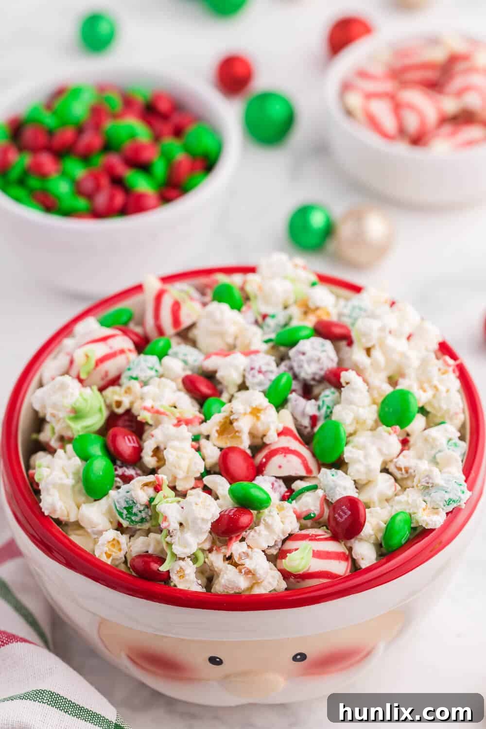 The finished Christmas popcorn recipe displayed beautifully in a festive Santa-themed serving bowl.