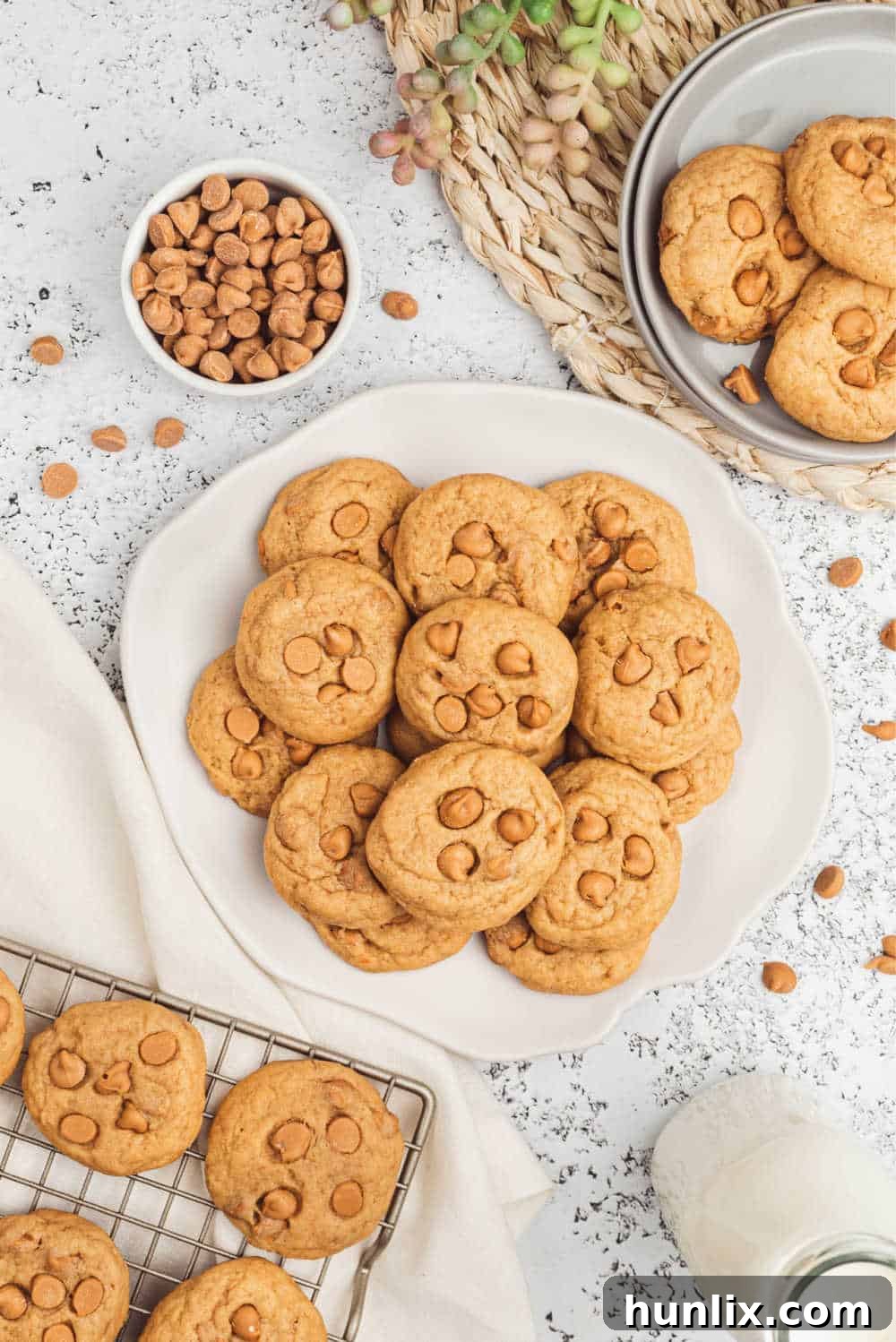A plate of golden-brown butterscotch pudding cookies, showing their soft, chewy texture and visible butterscotch chips.
