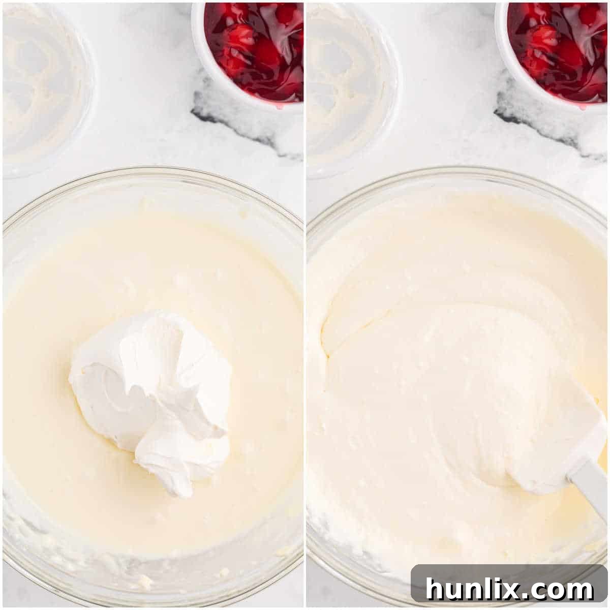 A creamy, white dip mixture in a glass bowl, with Cool Whip being gently folded in using a spatula, creating a light and airy texture for the cheesecake dip.