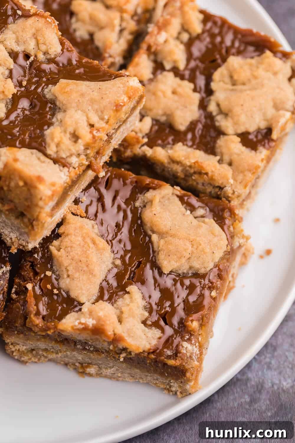 Golden Dulce Delights 8 A single dulce de leche bar on a white plate, showing the distinct layers.