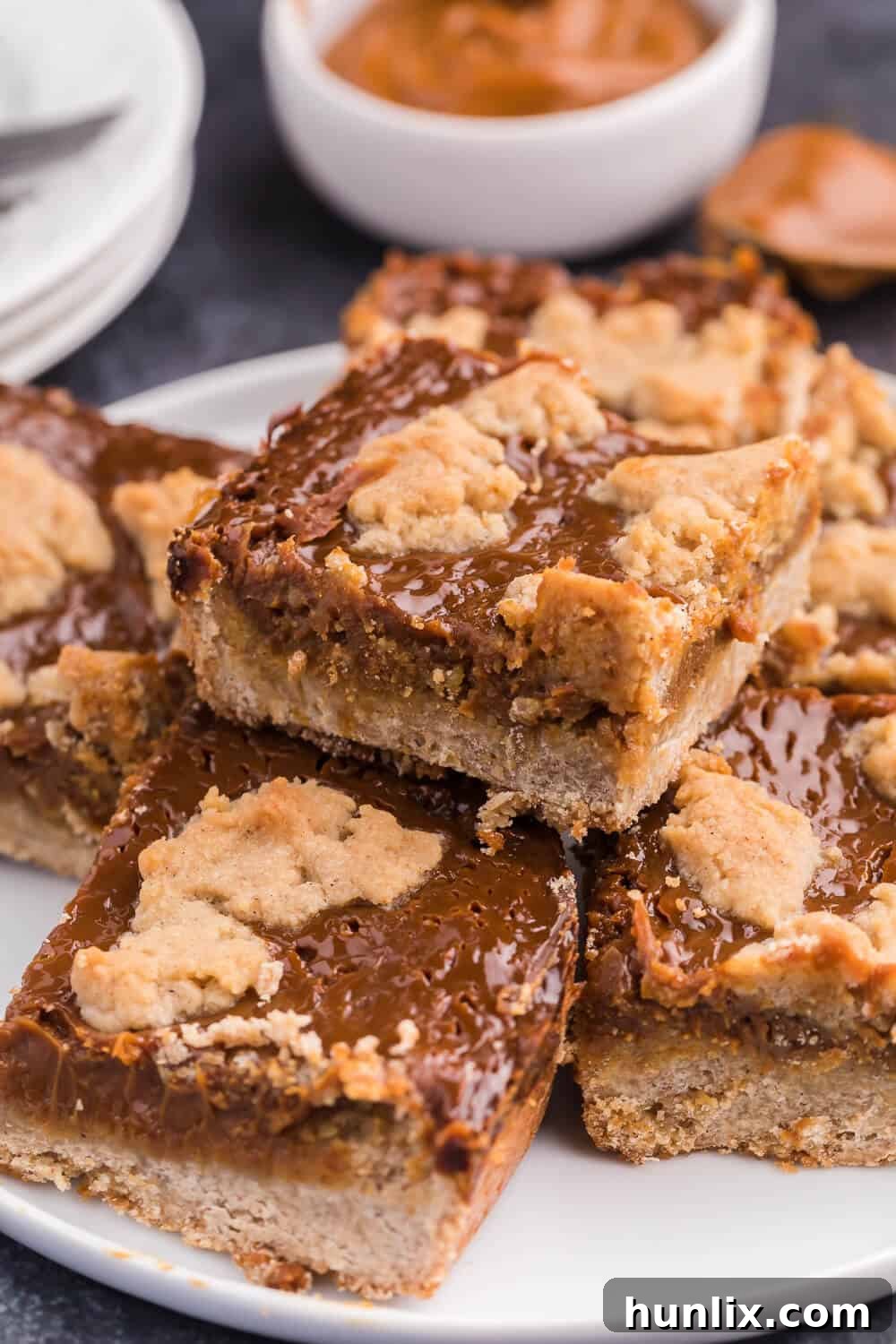 Golden Dulce Delights 9 Several dulce de leche bars stacked neatly on a plate, highlighting their texture.