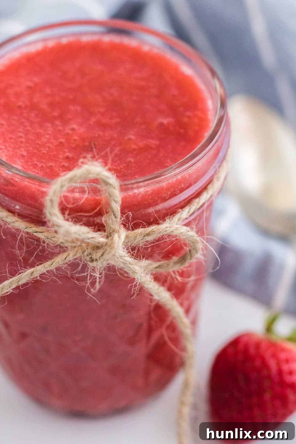 Effortless Instant Pot Strawberry Jam 8 A sealed mason jar filled with vibrant Instant Pot Strawberry Jam, ready for storage or gifting.