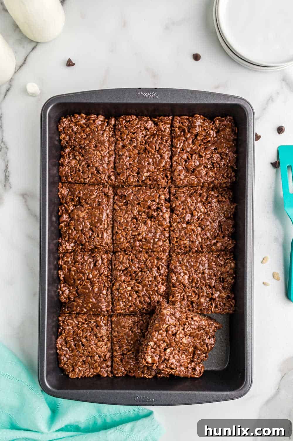 Chocolate rice krispies cut in a baking pan.
