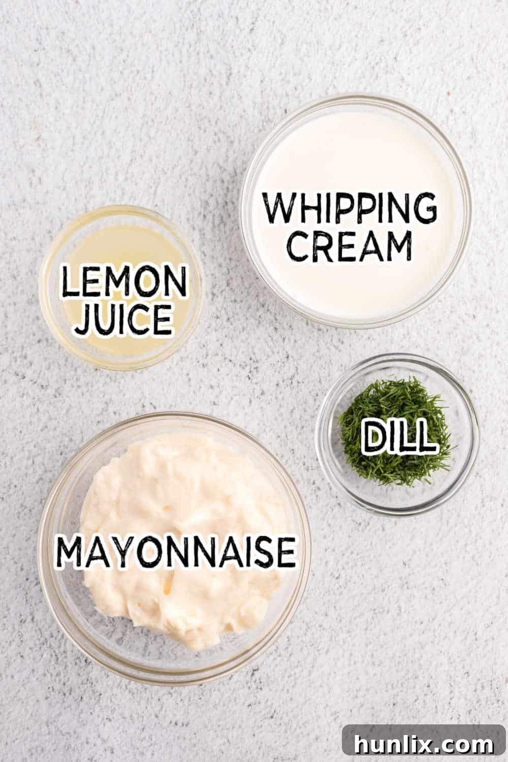 Zesty Shrimp Pasta Salad 4 Separate ingredients for the creamy dill dressing, including whipping cream, mayonnaise, fresh dill, and a lemon.