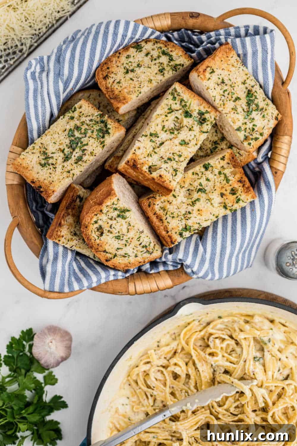 Sliced garlic bread in a brown woven basket, ready to be served or stored.