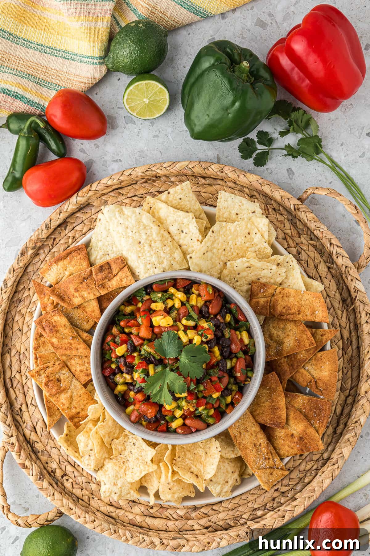 A vibrant bowl of Cowboy Caviar surrounded by tortilla chips, ready to be served.