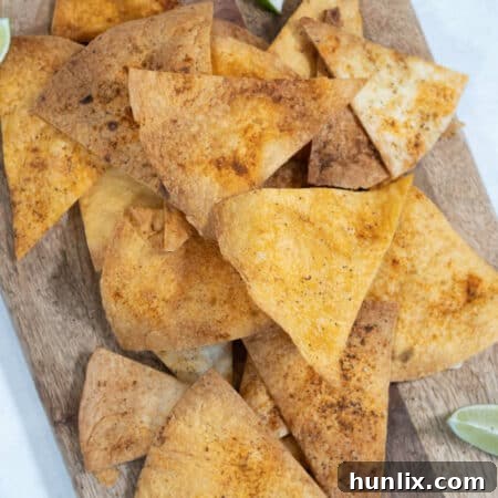 Crispy Air Fryer Tortilla Chips served on a wooden cutting board.