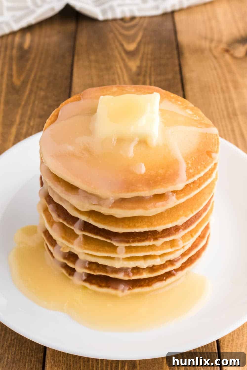 Golden Pancake Drizzle 8 A stack of pancakes on a plate.