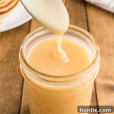 Golden Pancake Drizzle 9 The recipe in a mason jar and spoon drizzling over top.