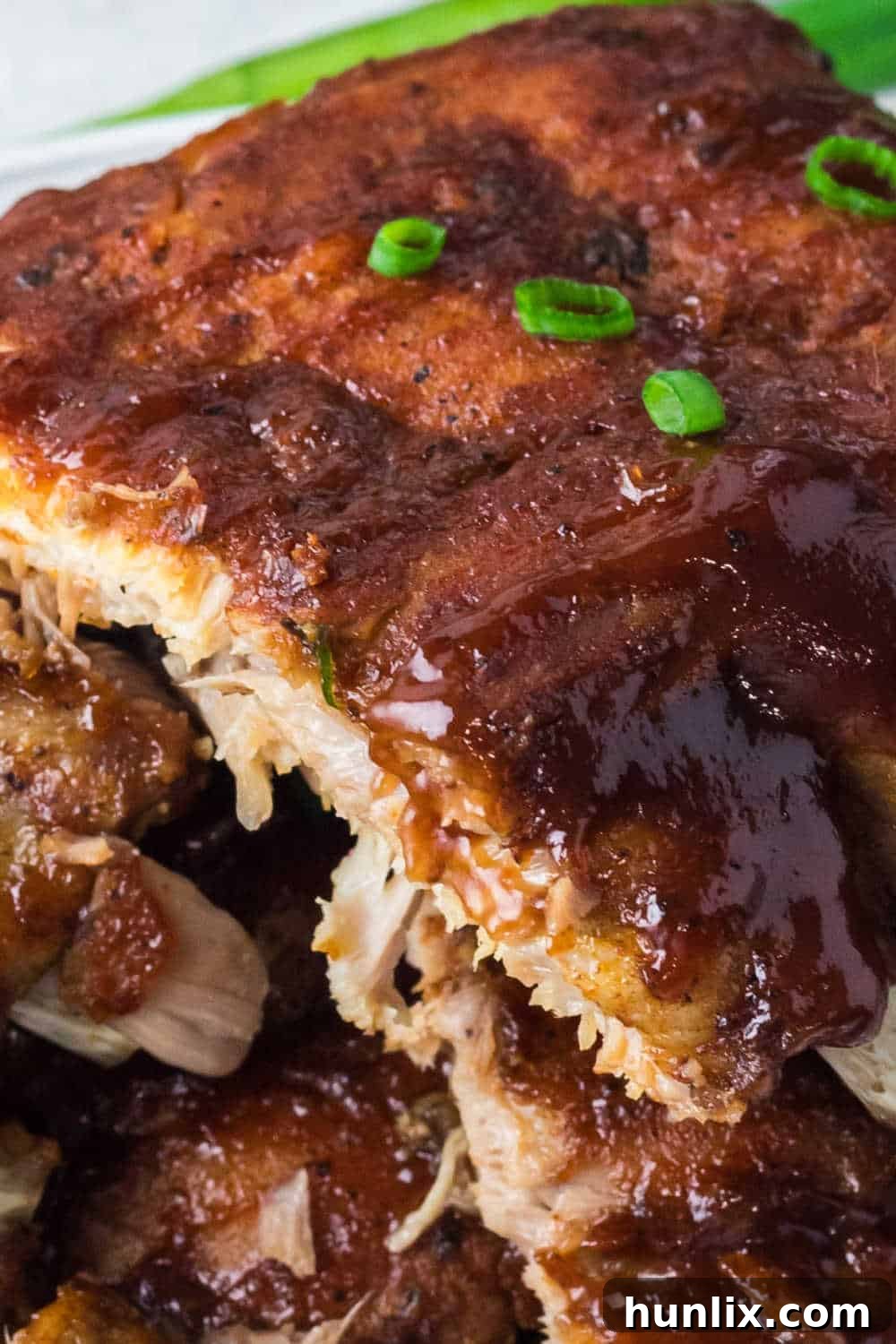 Fall-Off-The-Bone Instant Pot BBQ Ribs 10 Instant Pot BBQ Pork Ribs stacked on a plate.