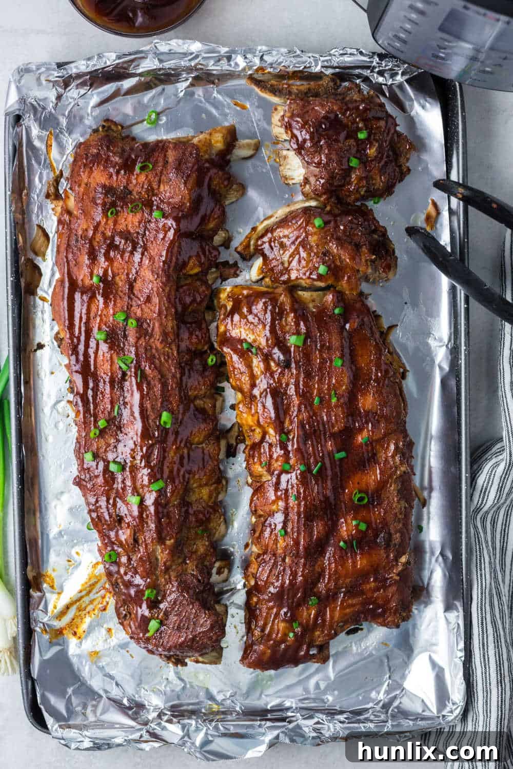 Fall-Off-The-Bone Instant Pot BBQ Ribs 7 Instant Pot BBQ pork ribs on a baking sheet.