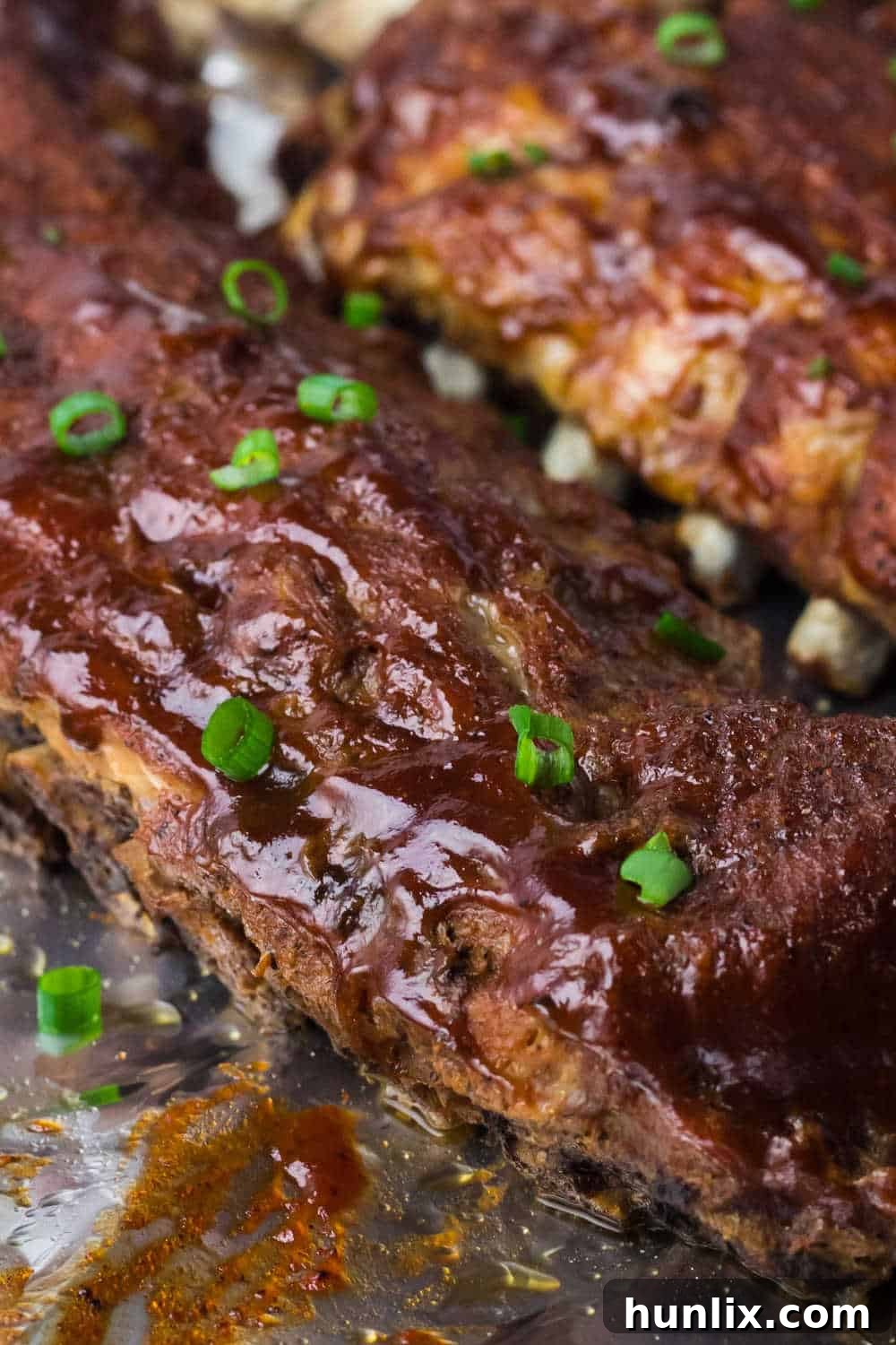 Fall-Off-The-Bone Instant Pot BBQ Ribs 8 Instant Pot BBQ pork ribs on a baking sheet.
