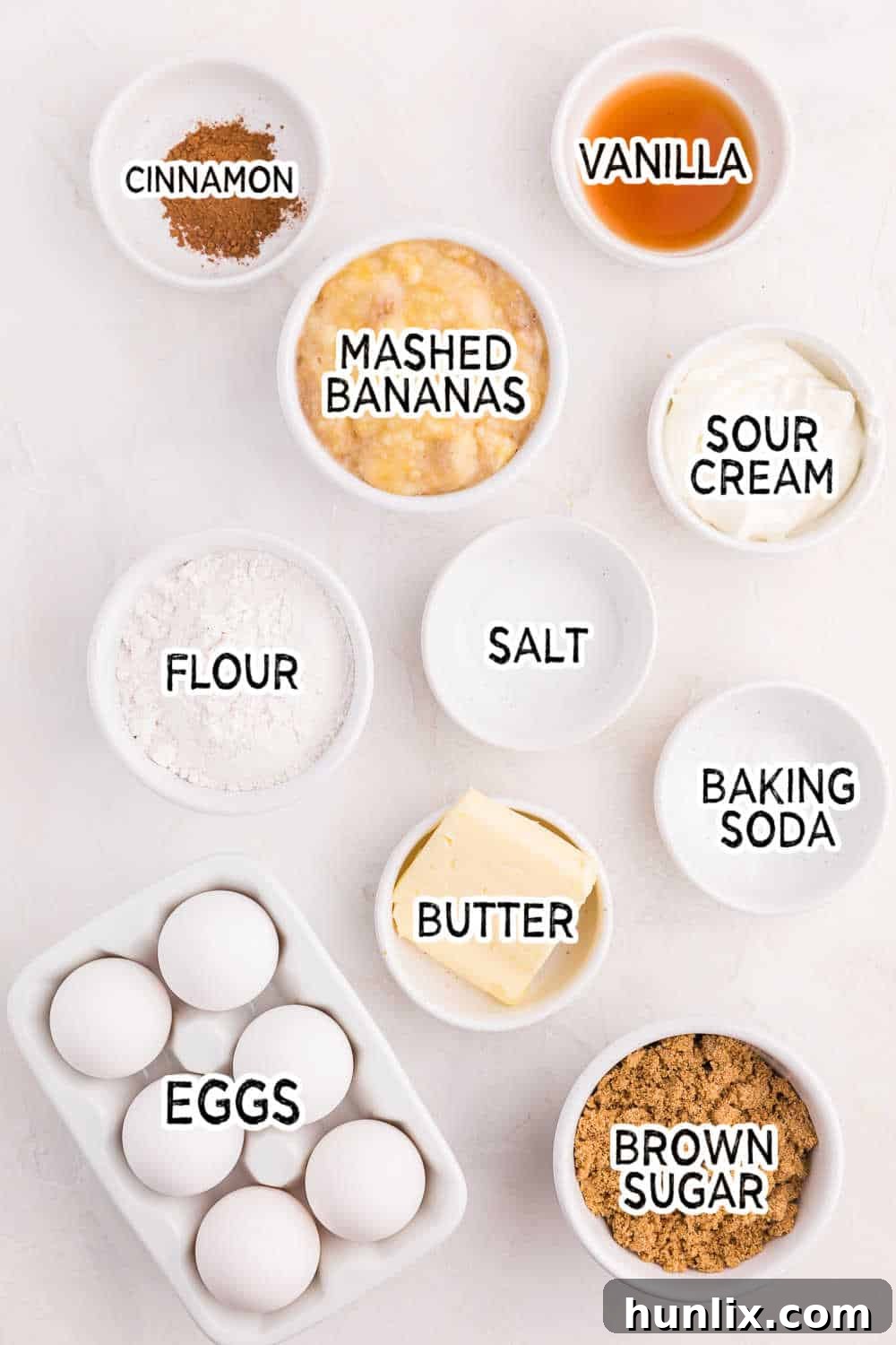Various ingredients laid out on a kitchen counter, ready for making banana bread.