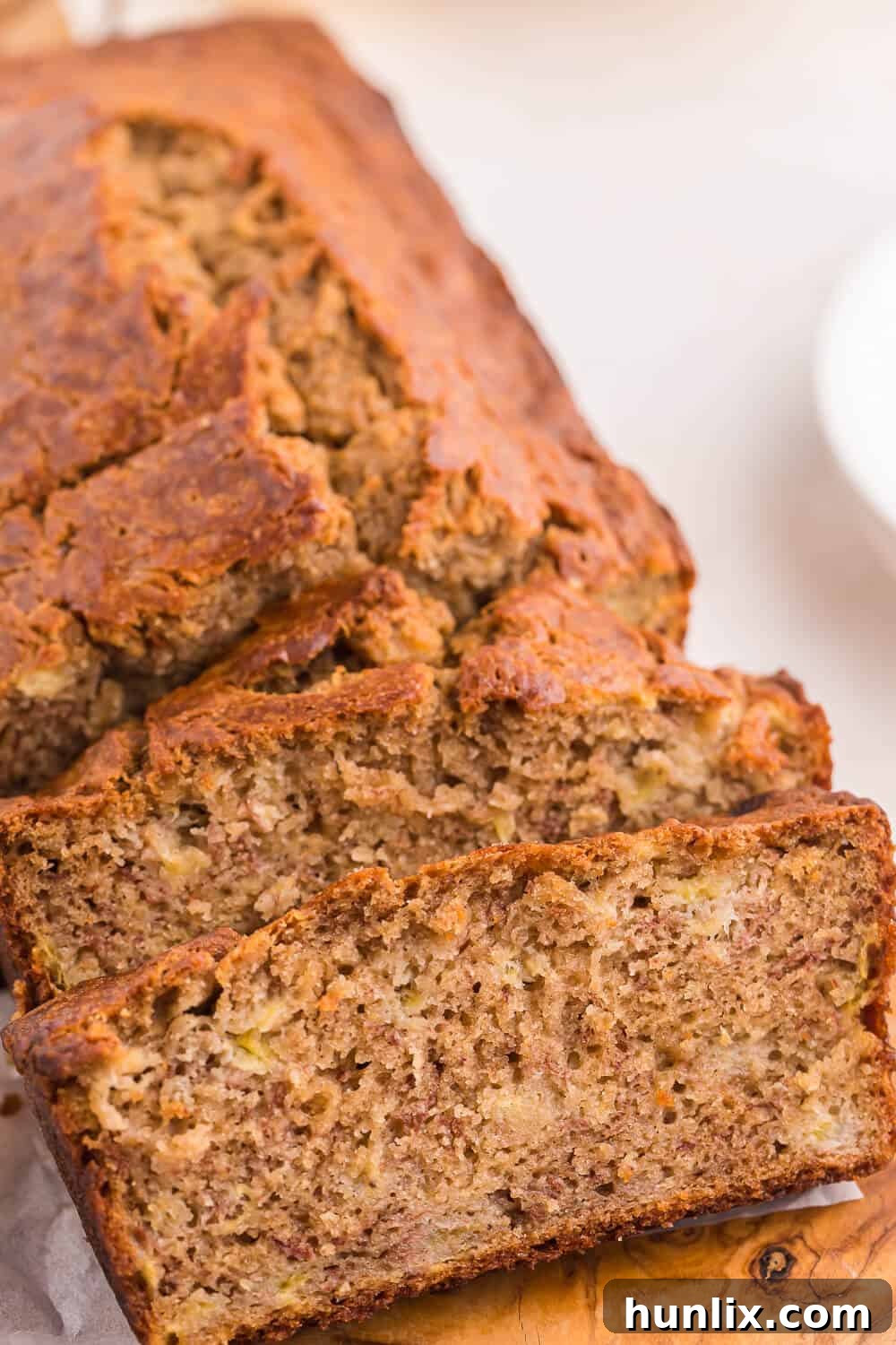 A loaf of banana bread with a few slices cut, ready to be enjoyed or stored.