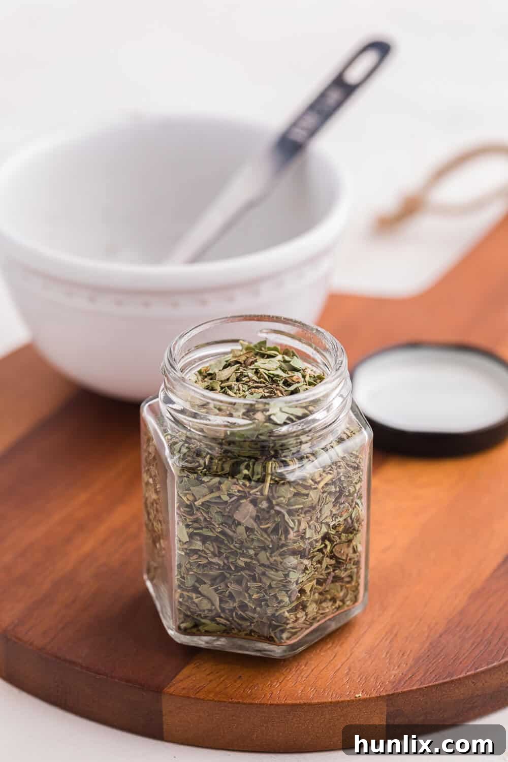 Italian seasoning in a spice jar, showcased on a kitchen counter.