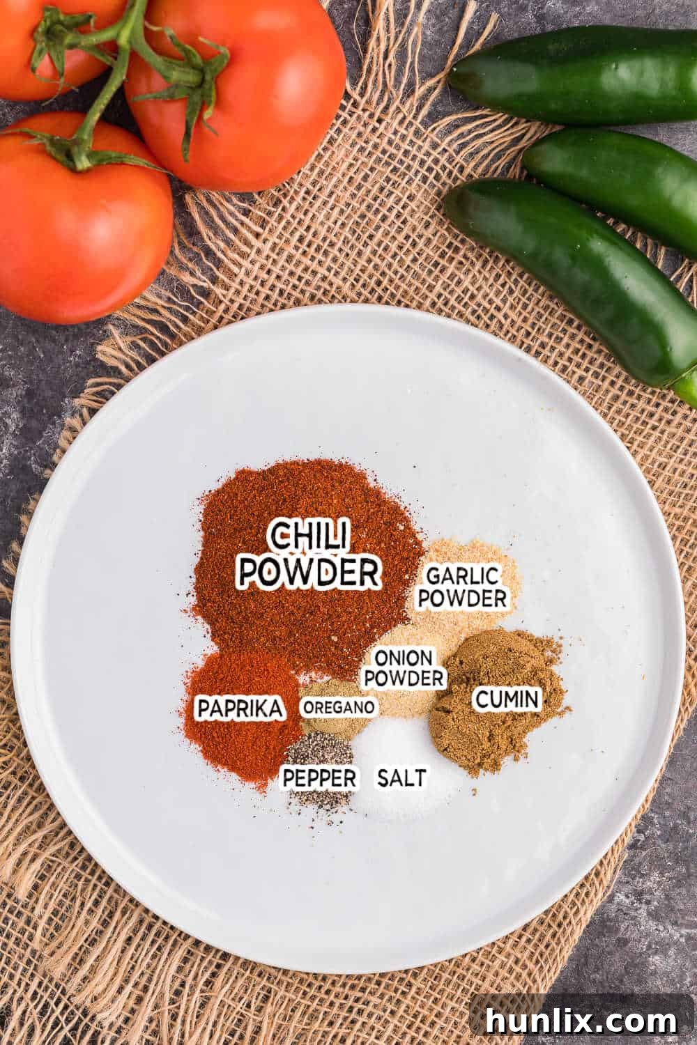 Ingredients for homemade taco seasoning arranged on a white plate, ready for mixing.