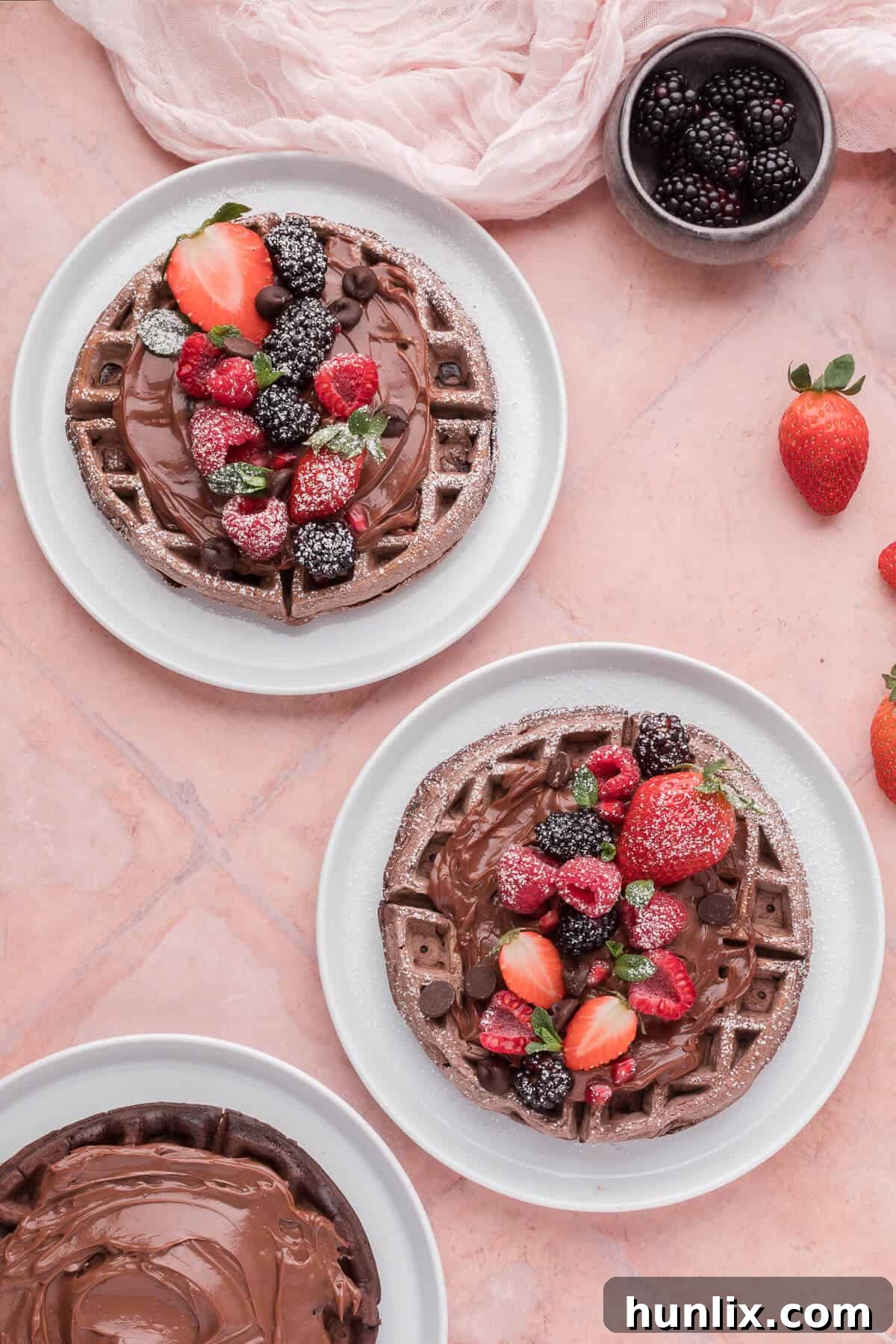 Pure Chocolate Waffle Bliss 2 Rich chocolate waffles on a plate, drizzled with chocolate sauce and adorned with fresh berries, promising a luxurious breakfast.