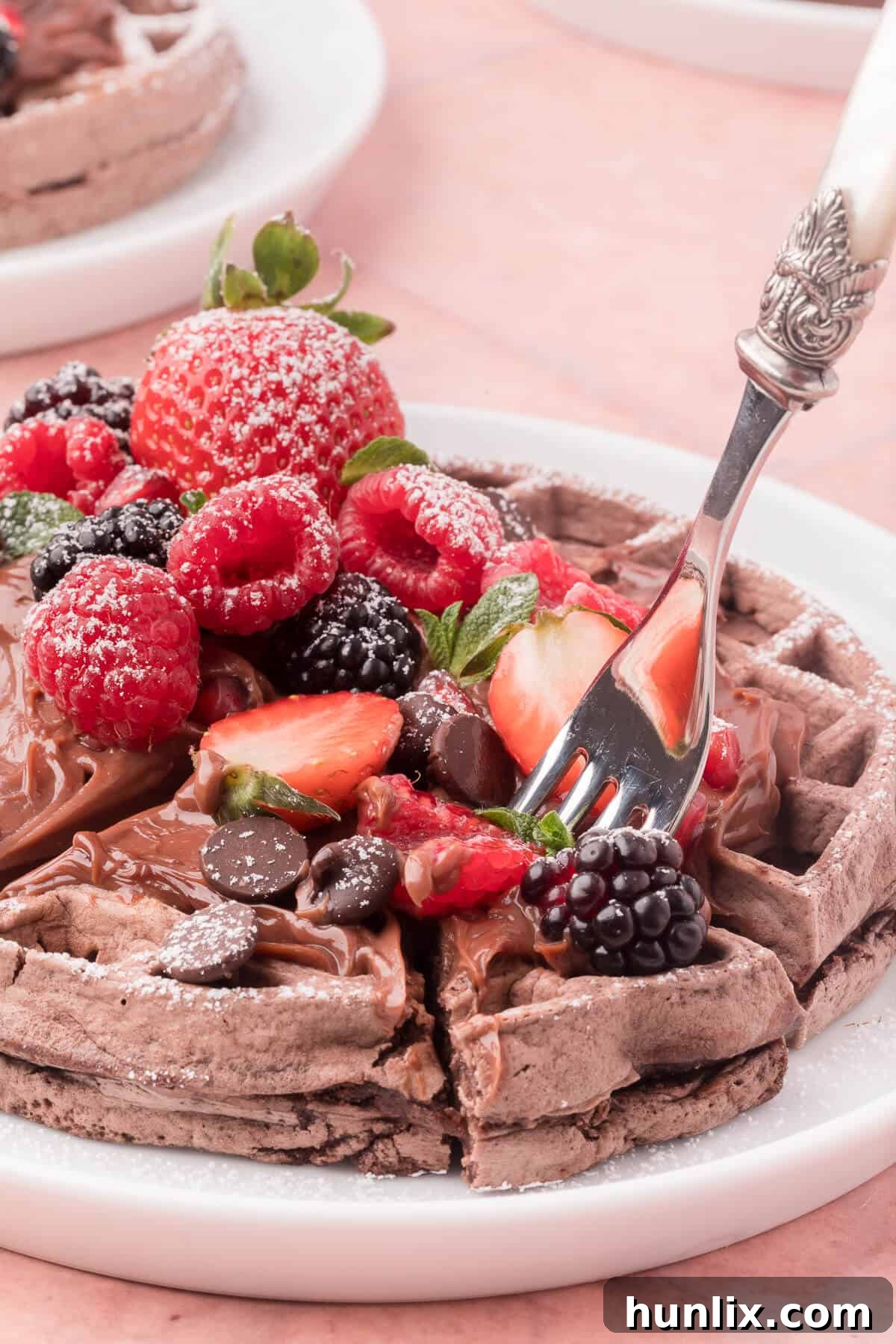 Pure Chocolate Waffle Bliss 11 A stack of chocolate waffles on a plate, with a fork ready to enjoy.