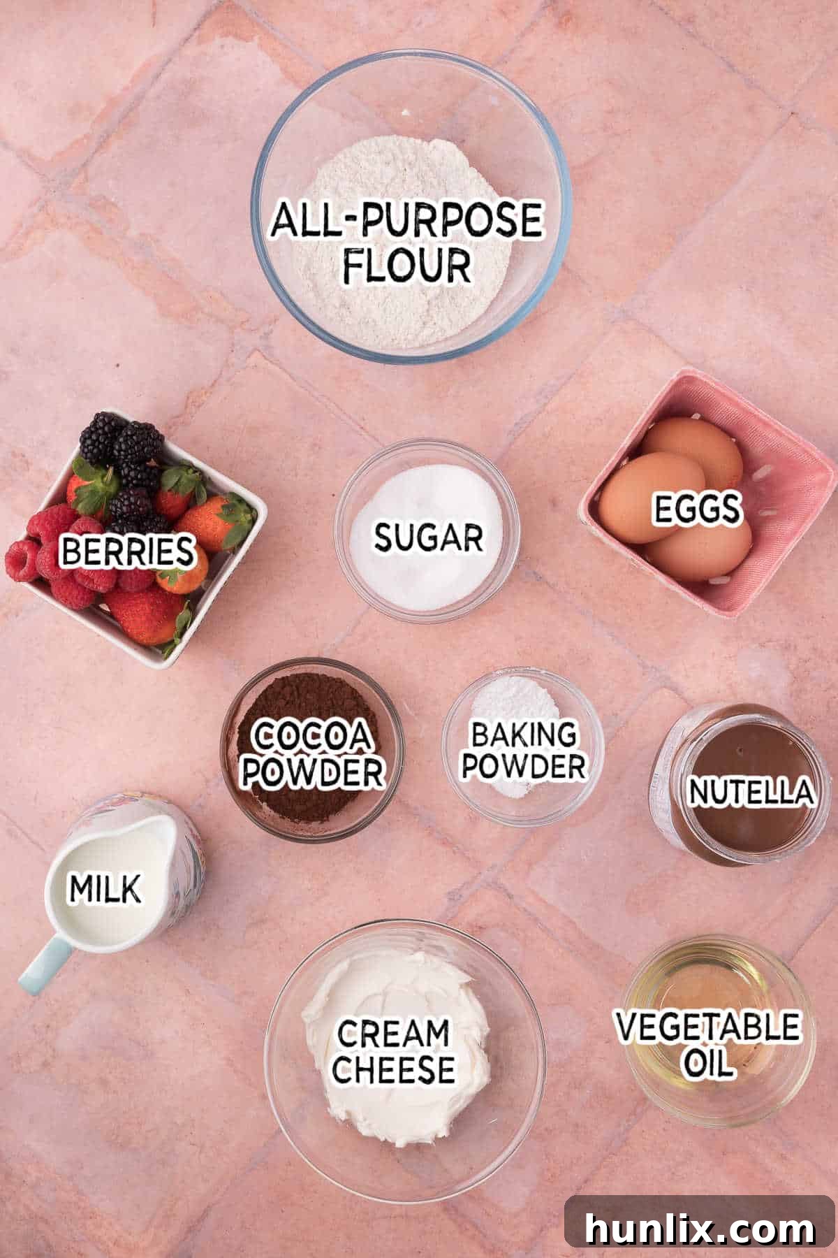 Pure Chocolate Waffle Bliss 3 A collection of fresh ingredients laid out for making chocolate waffles, including flour, cocoa powder, eggs, milk, and oil.