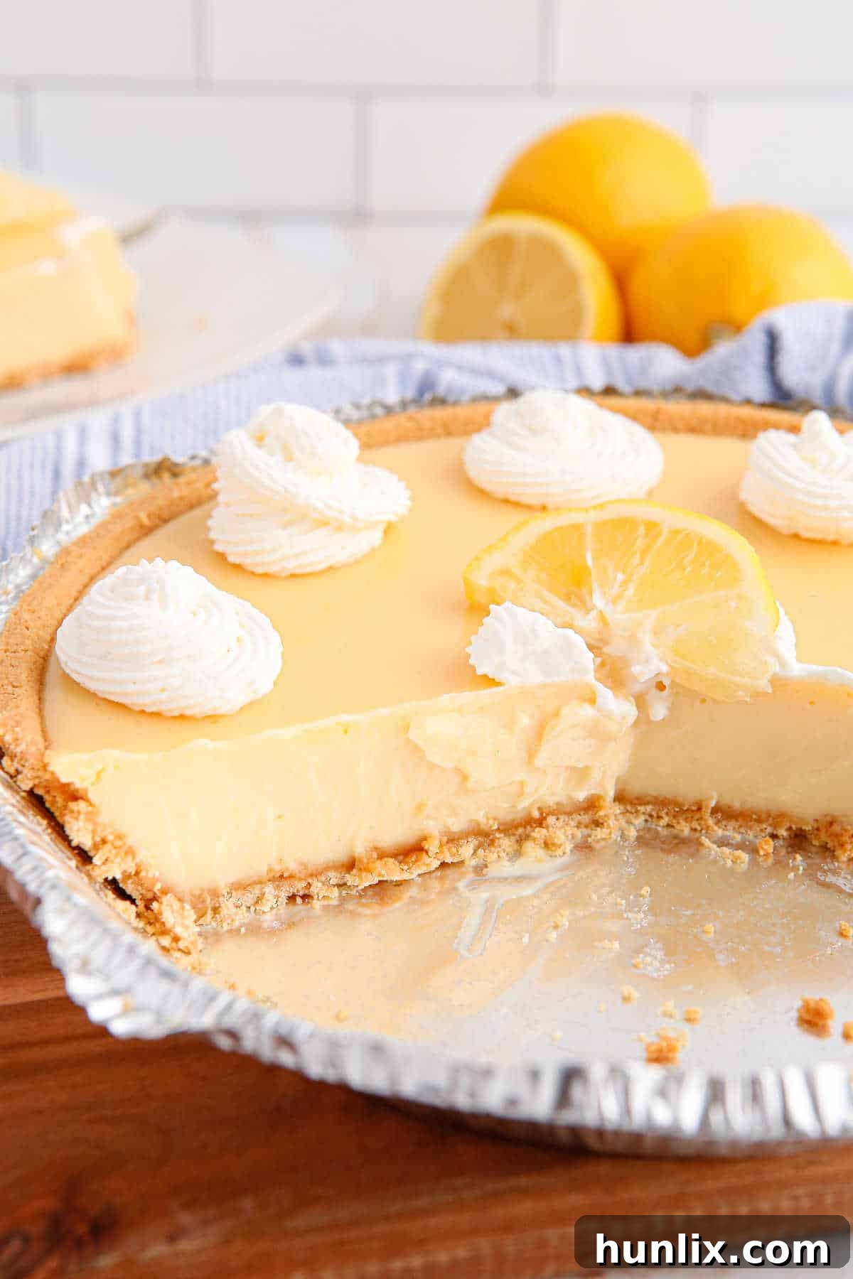 Classic lemon pie with slices cut out.