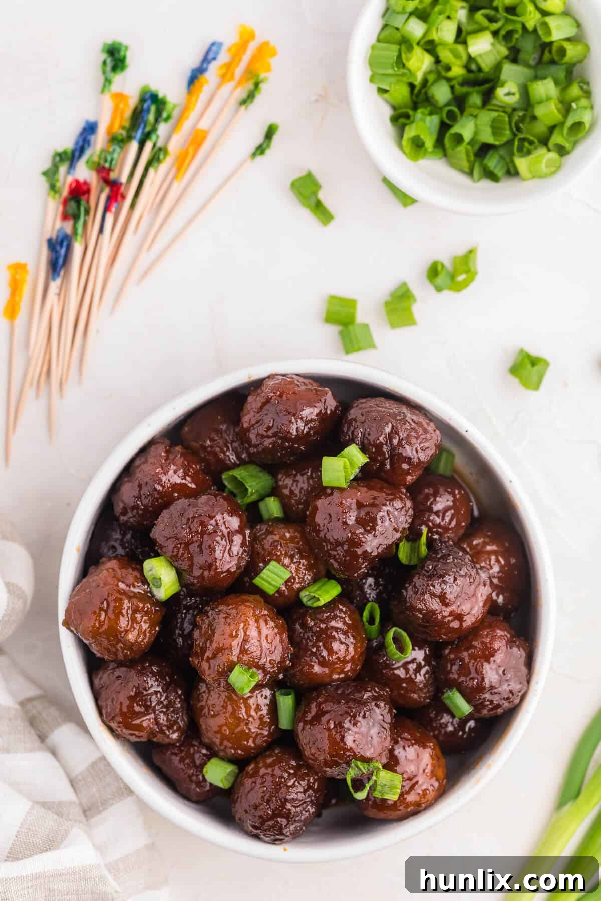 Grape-Glazed Meatballs 7 Grape jelly meatballs in a bowl.