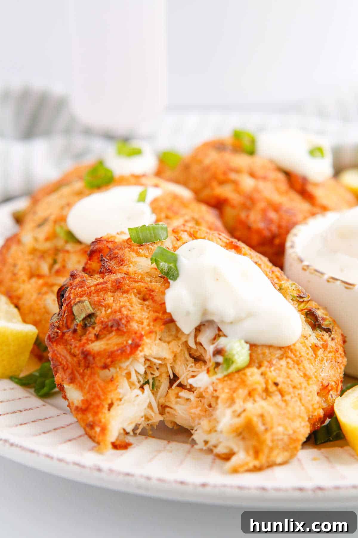 Perfectly Crispy Air-Fried Crab Cakes 9 A close-up shot of an Air Fryer Crab Cake with a bite taken out, revealing its tender, flaky interior.