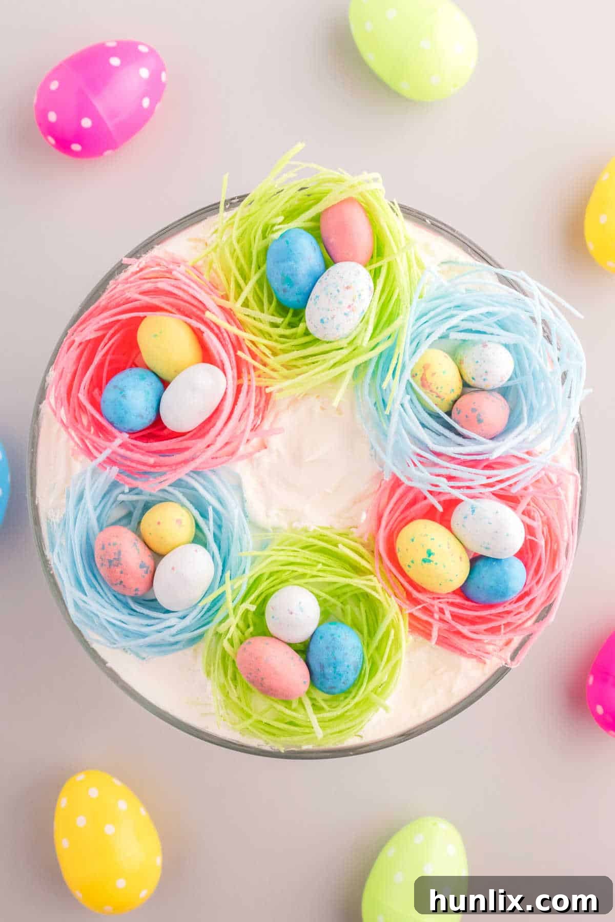 Overhead view of Easter Trifle in a trifle bowl, showcasing its colorful layers.