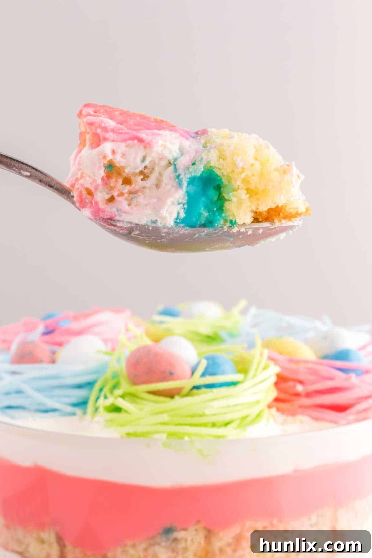The Easter Trifle in a serving spoon, showing a cross-section of its layers.