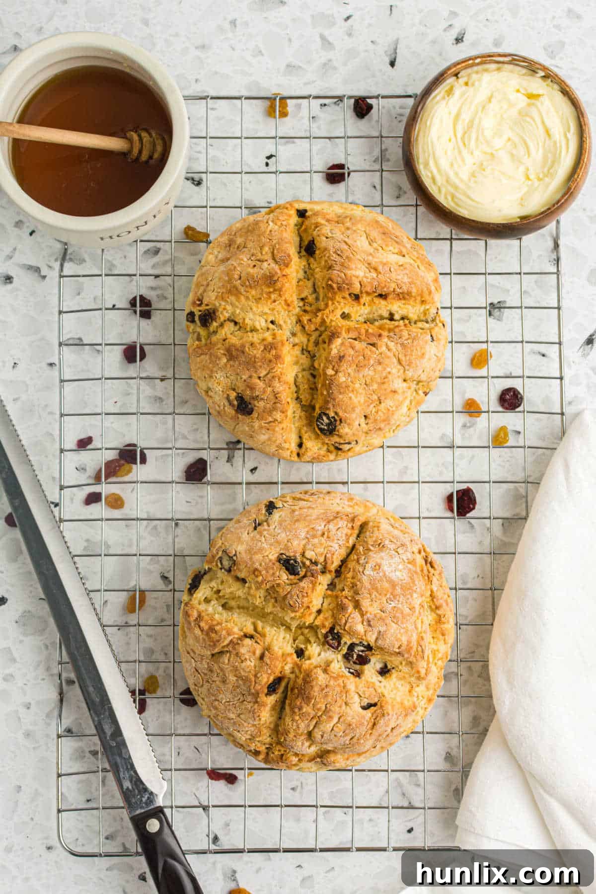 Two golden-brown loaves of Air Fryer Irish Soda Bread cooling on a wire rack, ready to be sliced and enjoyed.
