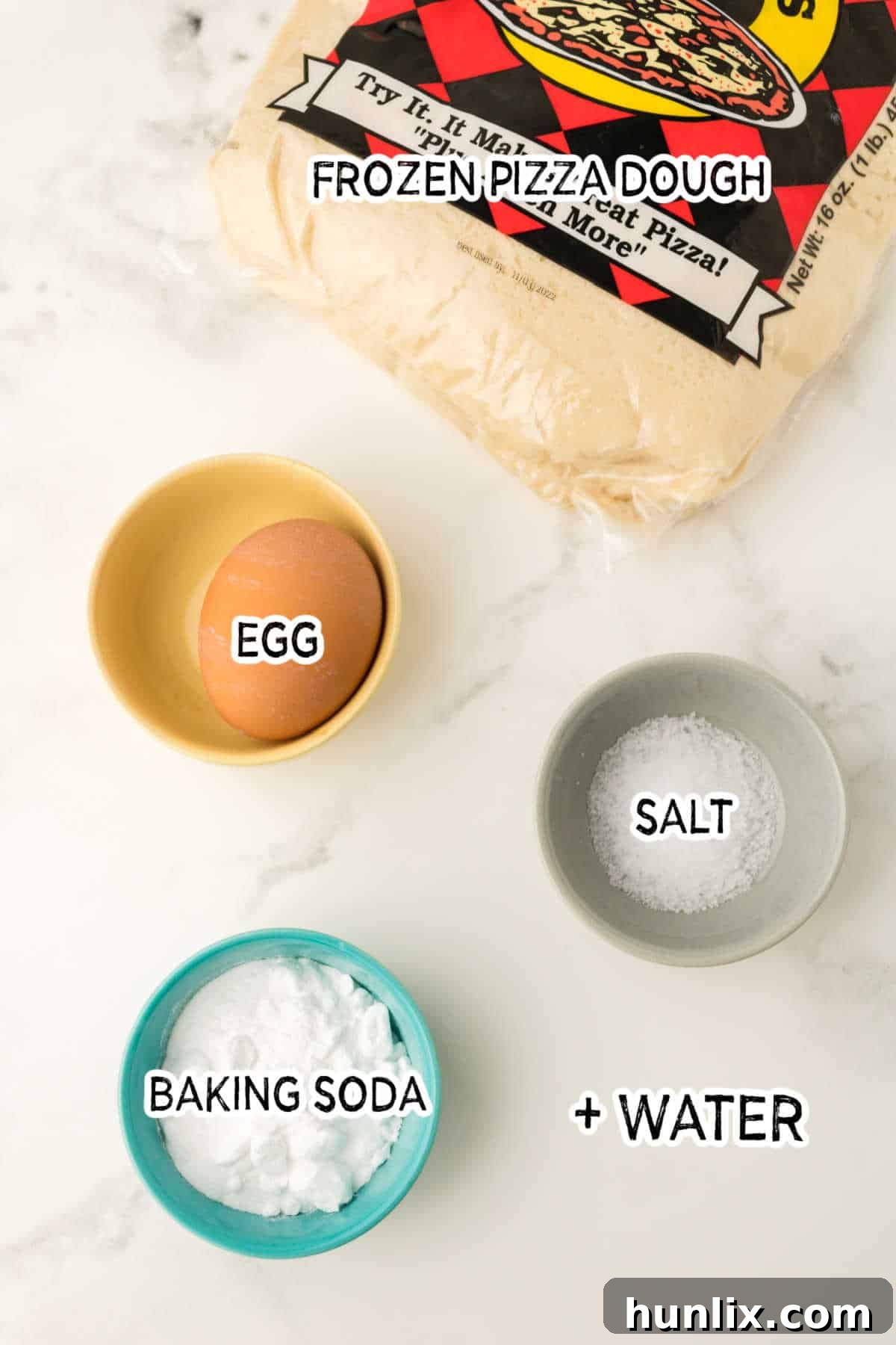 Golden Air Fryer Pretzel Poppers 3 Various ingredients for pretzel bites laid out on a white marble countertop.