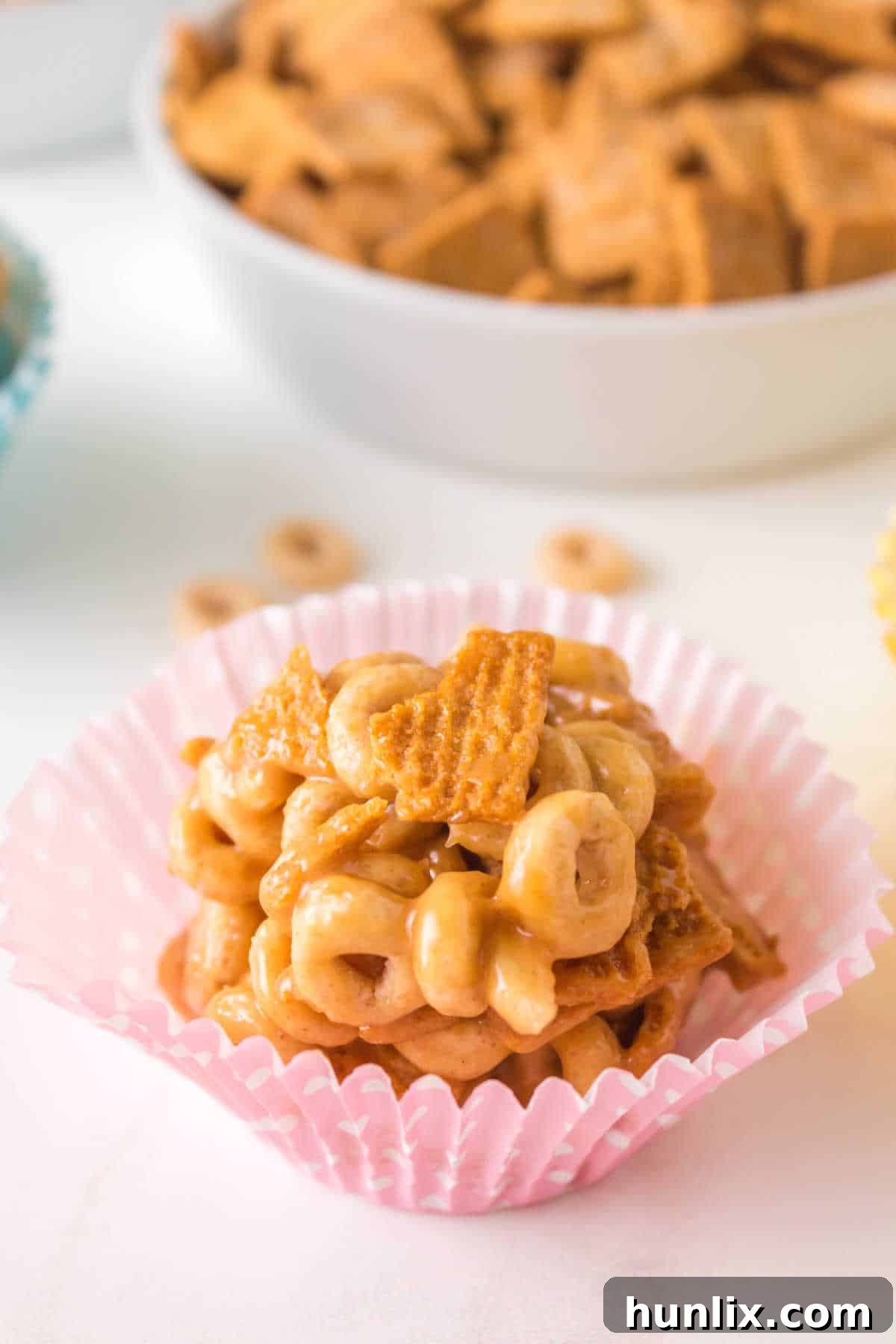 Peanut butter Cheerios Ball in a pink cupcake liner.