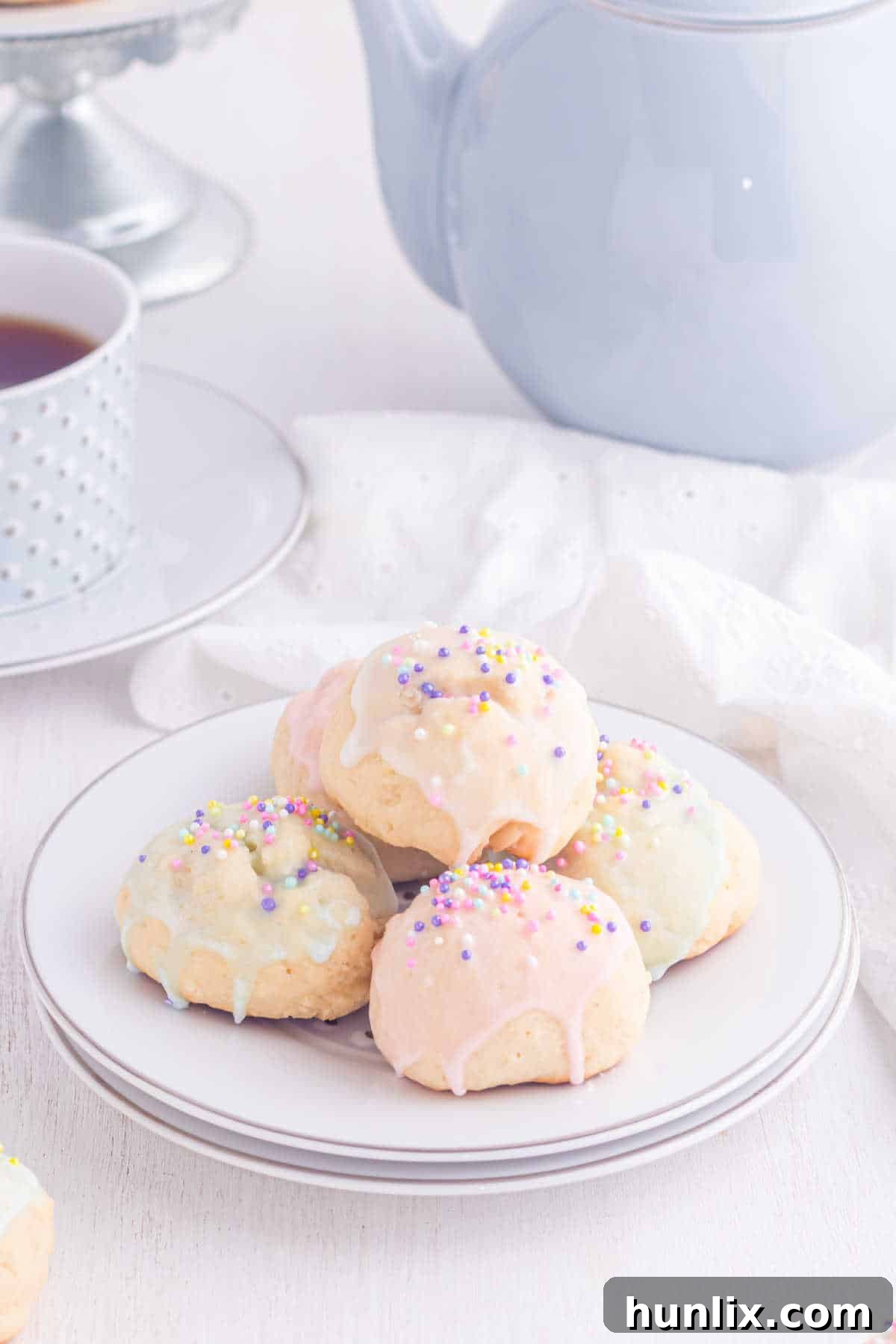Sweet Italian Easter Delights 2 Delicate Italian Easter Cookies arranged beautifully on a white plate, showcasing their almond glaze and festive sprinkles.