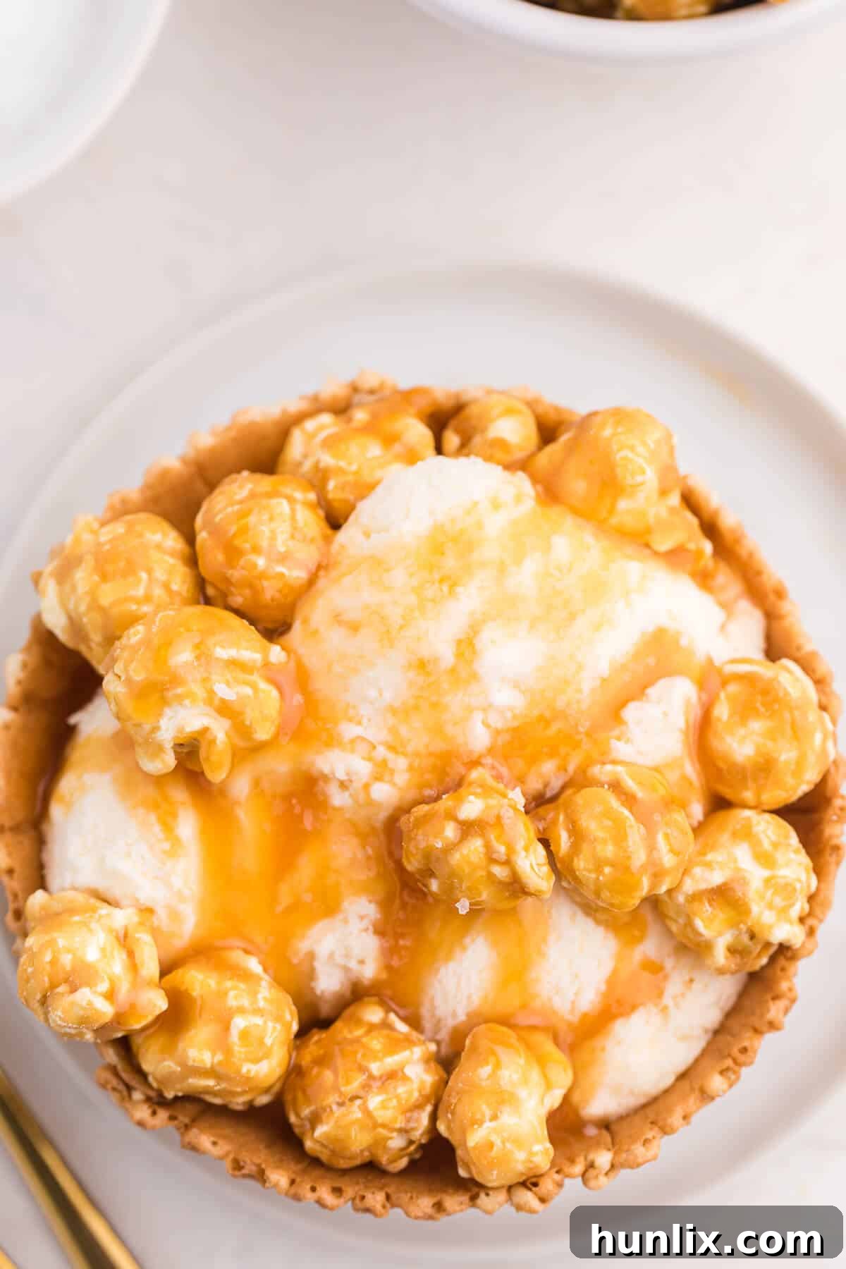 Golden Caramel Crunch Sundae 5 Another perspective of the Caramel crunch ice cream sundae in a waffle bowl, ready to be enjoyed.