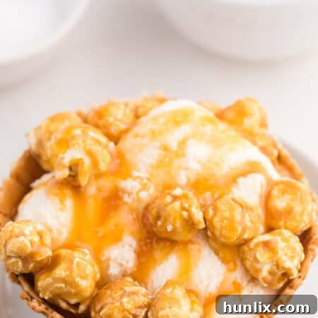 Golden Caramel Crunch Sundae 7 Caramel crunch ice cream sundae on a white plate.