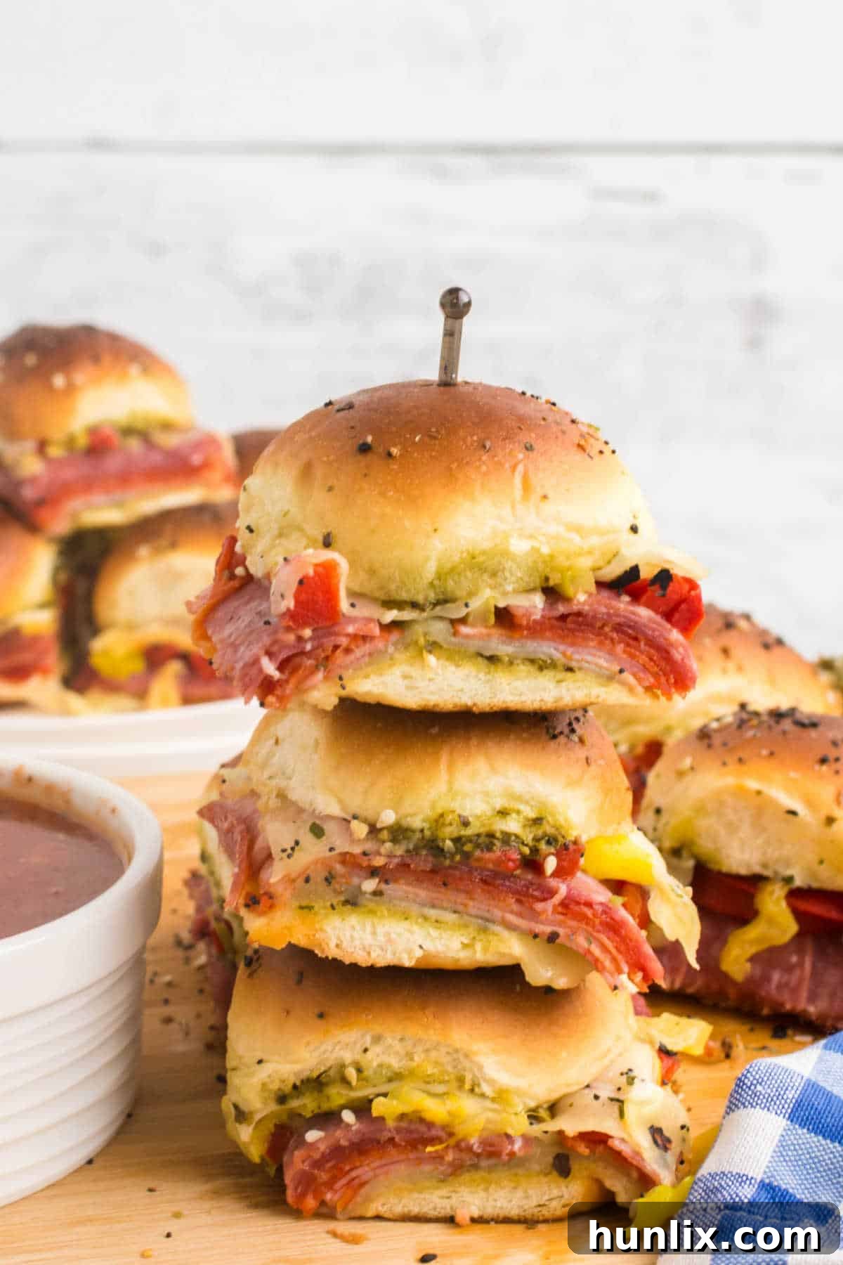 A beautifully stacked pile of Italian sliders, showing their layers of delicious fillings.