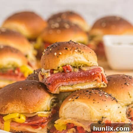 Italian sliders piled on a plate.