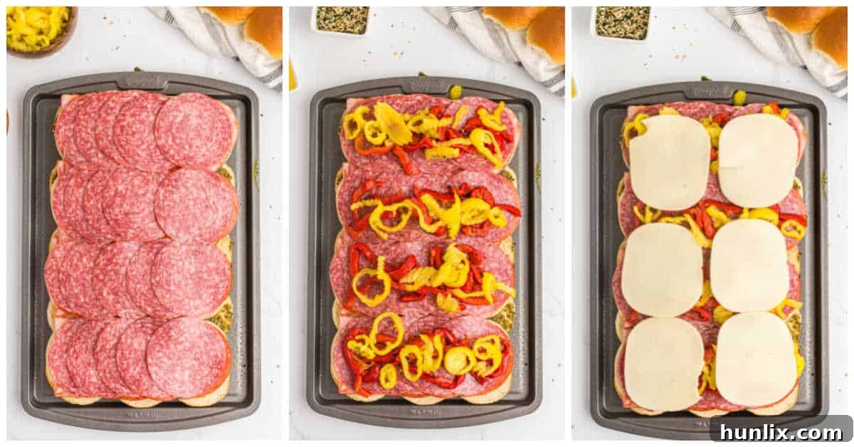 Adding roasted red peppers, banana peppers, and the final cheese layer to Italian sliders.