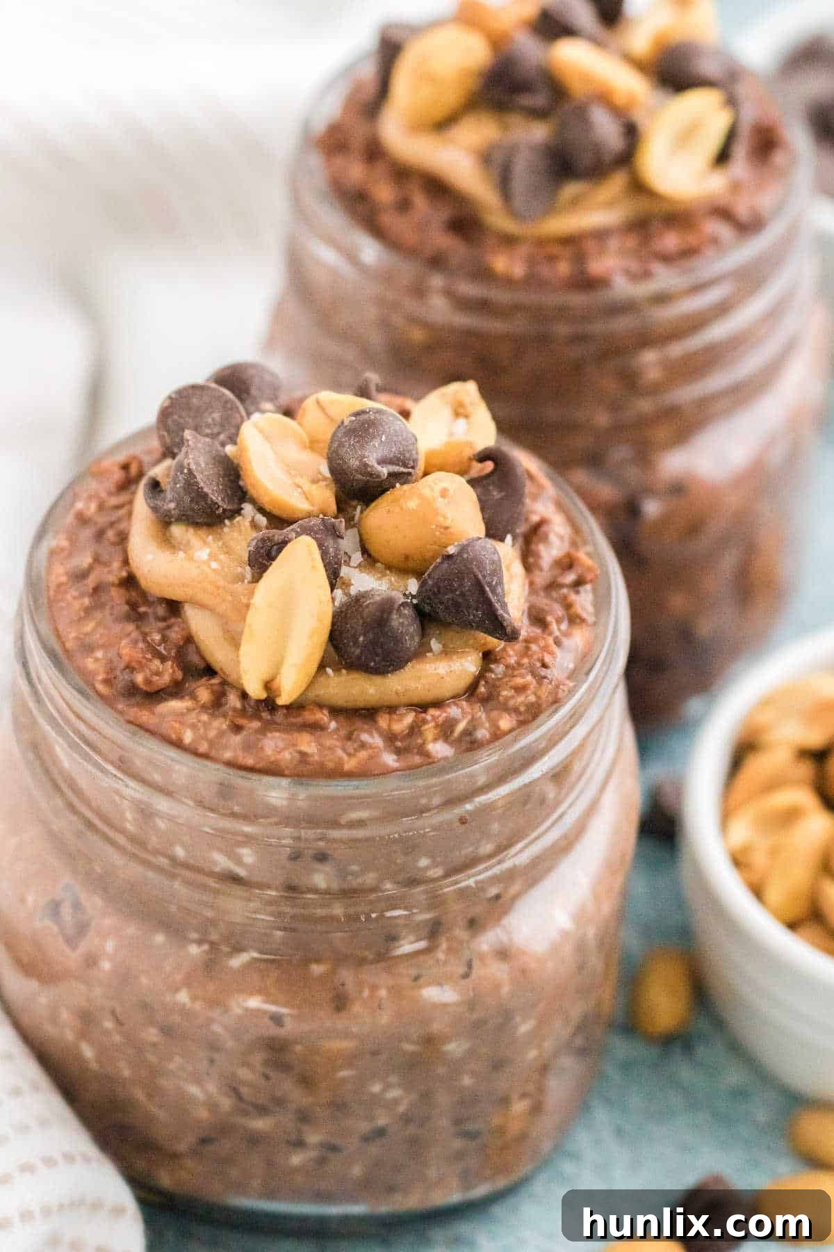 Dreamy Chocolate Peanut Butter Overnight Oats 5 Chocolate peanut butter overnight oats in mason jars, ready to be served.