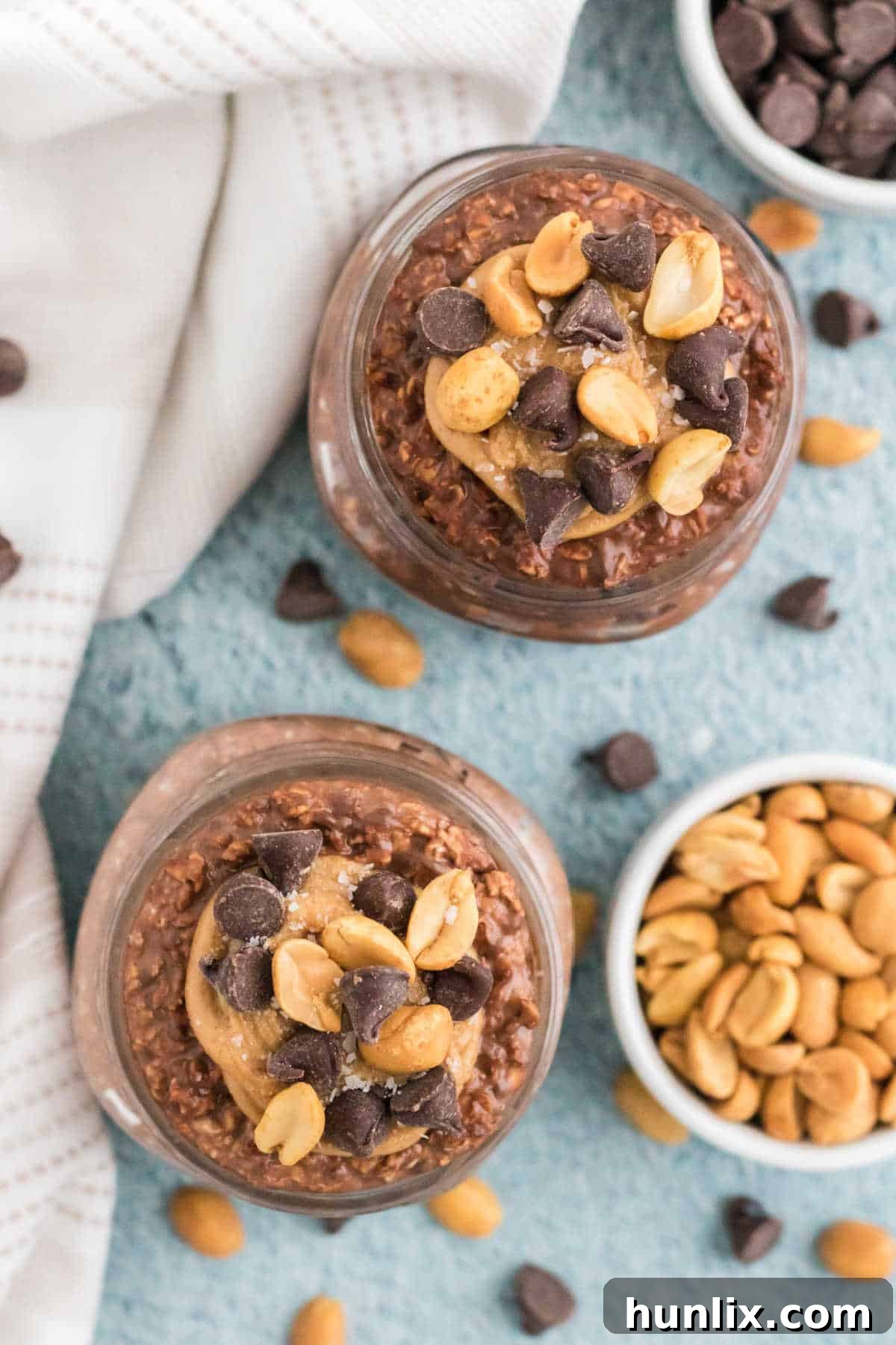 Dreamy Chocolate Peanut Butter Overnight Oats 6 Chocolate peanut butter overnight oats in mason jars with a spoon, highlighting the creamy texture.