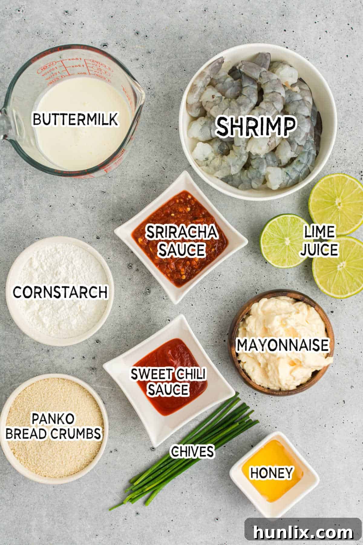 Crispy Air Fryer Bang Bang Shrimp 3 A selection of ingredients for Bang Bang Shrimp, including raw shrimp, buttermilk, panko, and various sauce components.