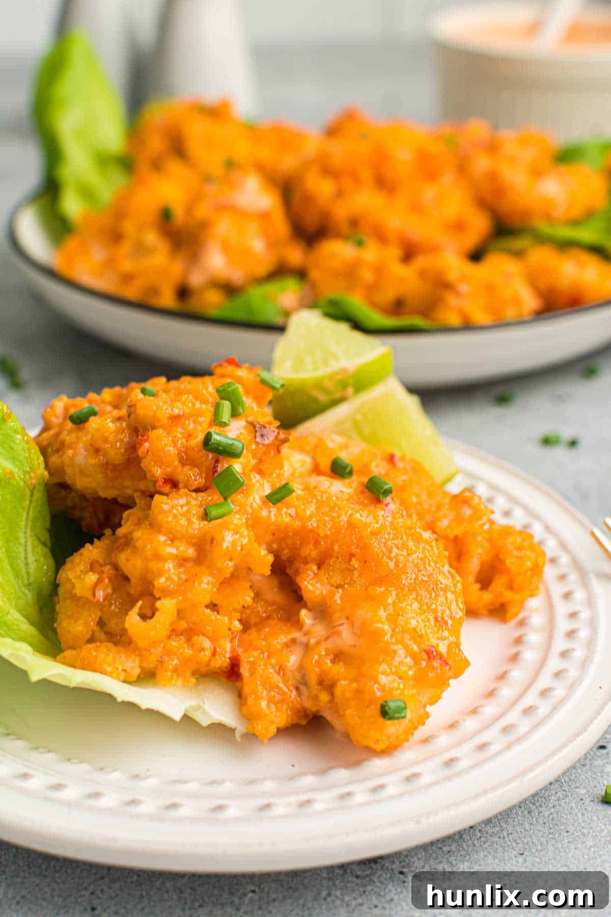 Crispy Air Fryer Bang Bang Shrimp 9 A close-up shot of crispy Air Fryer Bang Bang Shrimp on a plate, highlighting the delicious texture and sauce.