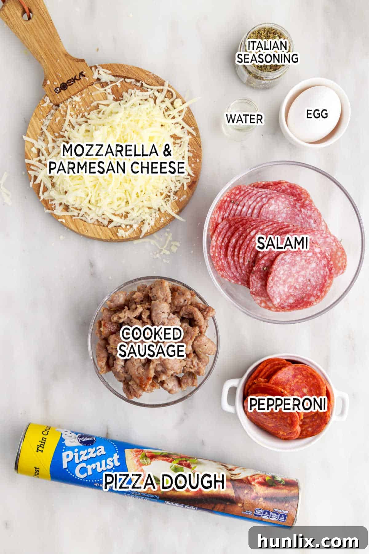 A collection of fresh ingredients laid out on a table, ready to be assembled into delicious meat calzones.