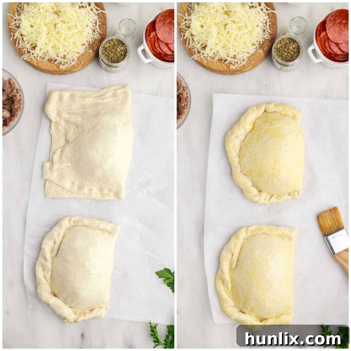 Two calzones on a baking sheet, brushed with egg wash and sprinkled with Italian seasoning, showcasing the final steps before baking.