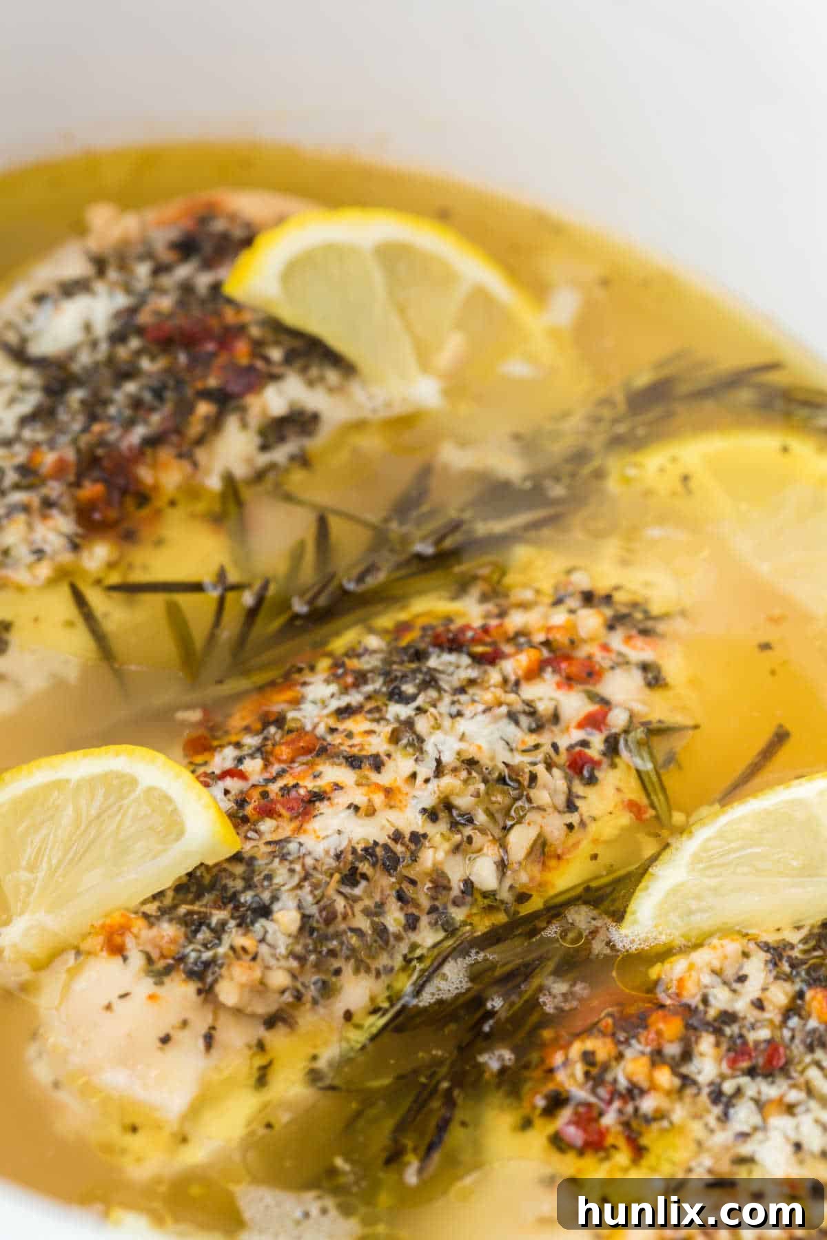 Lemon garlic butter chicken in a slow cooker.