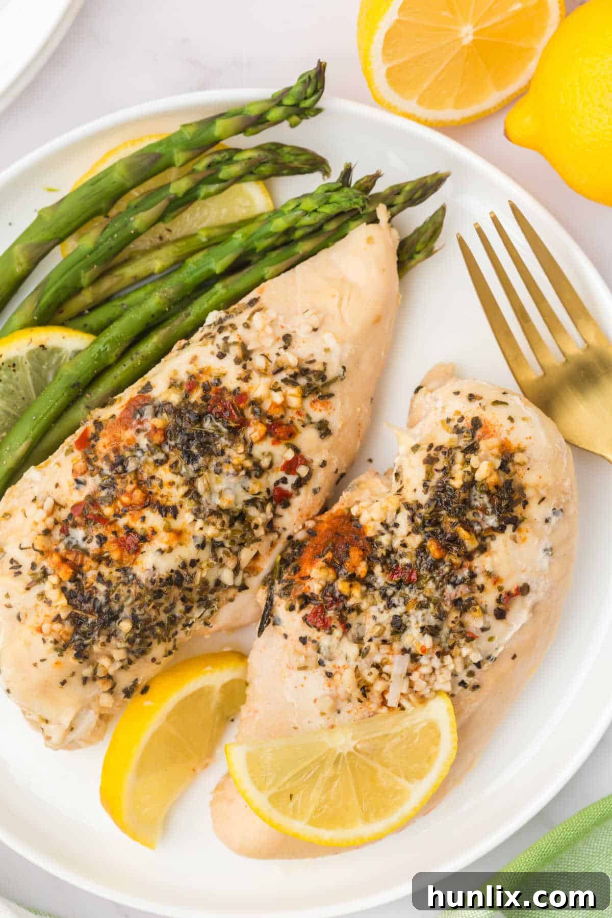 Lemon Garlic butter chicken on a plate with asparagus.