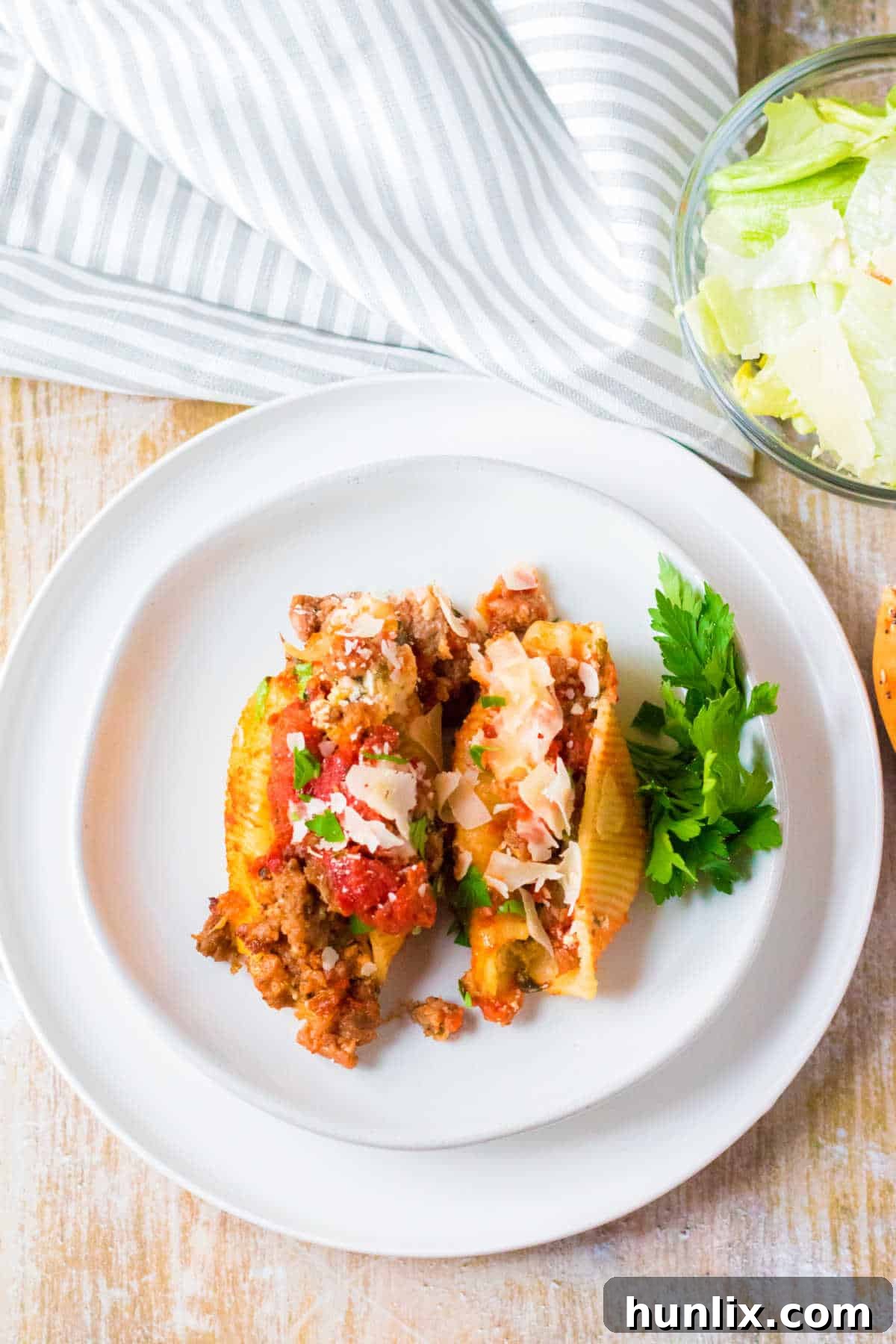 A plate with two stuffed shells on it.