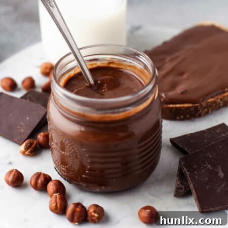 Homemade Nutella in a jar with a spoon.