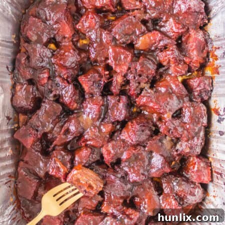 The recipe in an aluminum pan with a gold fork.